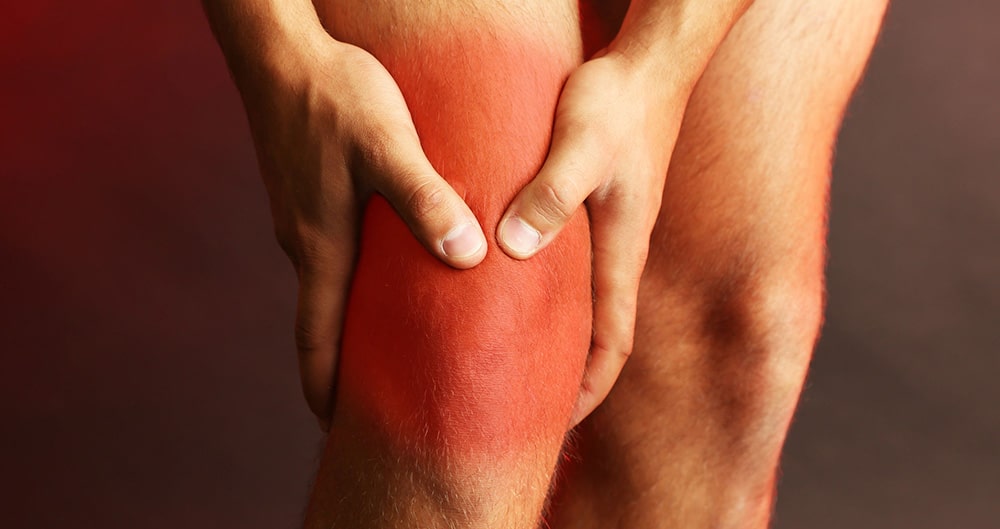 man soothing knee pain