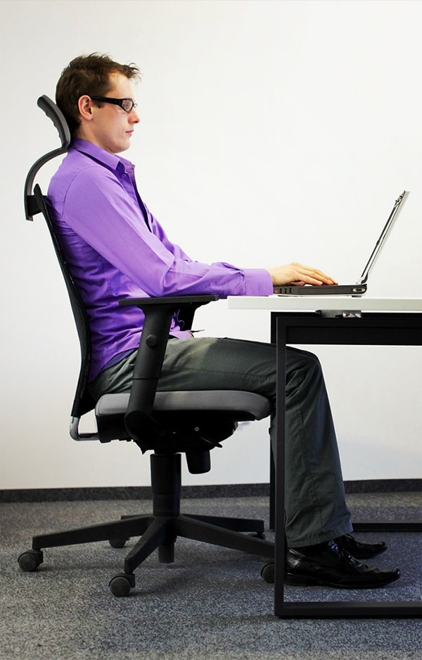 Man with back support from ergonomic chair