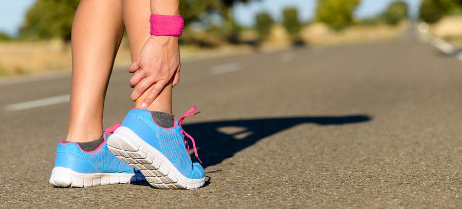female-runner-holding-ankle female runner holding ankle in pain