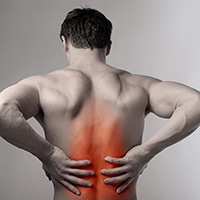 new-services-back-pain Man holding back indicating back pain