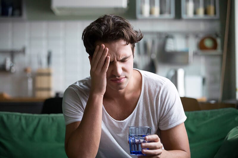 man experiencing nausea and dizziness