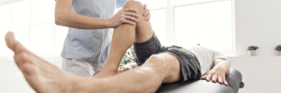 physical-therapy-help-cerebral-palsy Physical therapist exercising leg of man with cerebral palsy