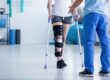 physical therapist helping a patient with a leg injury