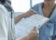 A healthcare provider goes over insurance coverage with their patient.