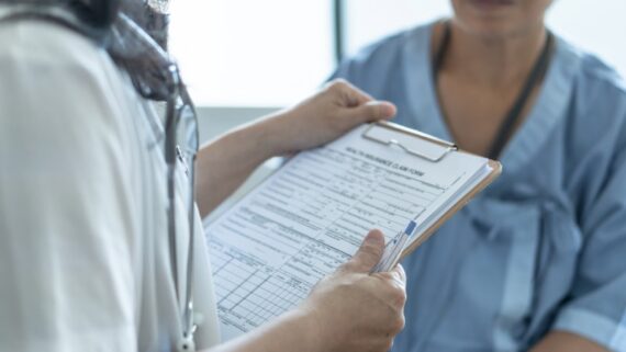 A healthcare provider goes over insurance coverage with their patient.