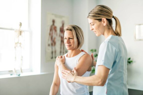 The Science Behind Physical Therapy: How It Works and Why It’s Effective Female physical therapist helping a female patient stretch.