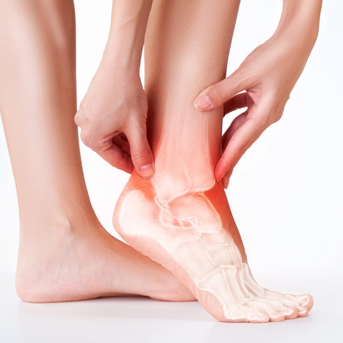 Person holding an inflamed ankle with visible skeletal structure, indicating pain or injury.